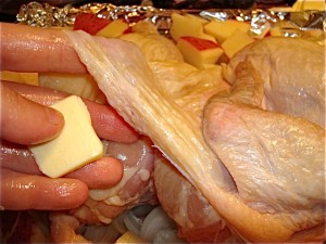 Lift the skin up and tuck the butter in, distributing it evenly