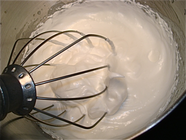 Whip the meringue til it starts to form stiff peaks