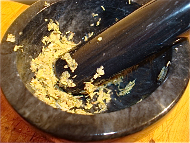 Mash up the herbs in a mortar and pestle