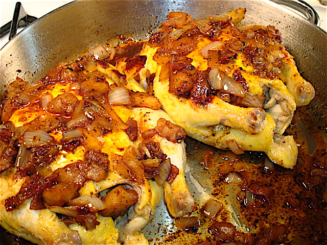 Cover the hens with the apple, onion, and bacon cider sauce