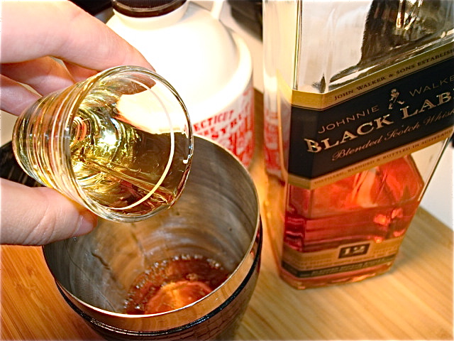 Add the whiskey to a cocktail shaker